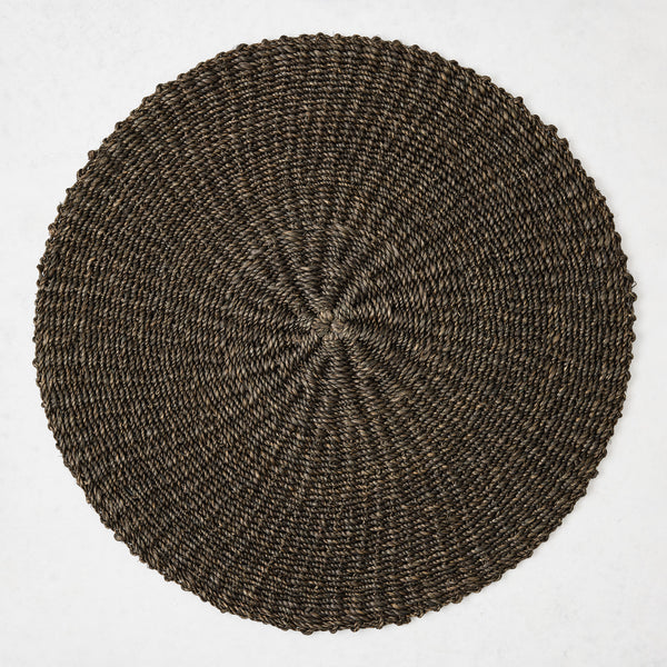 16-inch round placemat hand-woven from chocolate brown abaca fiber with a textured spiral pattern.