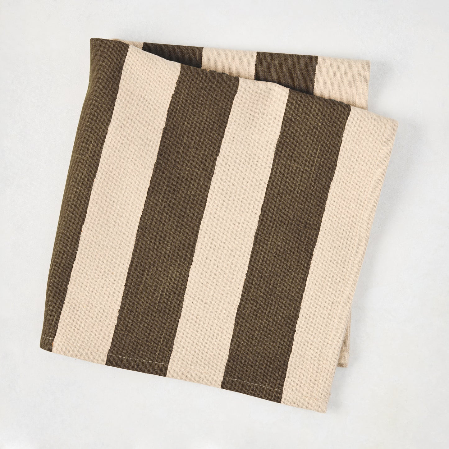 Folded Chocolate Brown Hampton Stripe natural cotton napkin, 22" square.