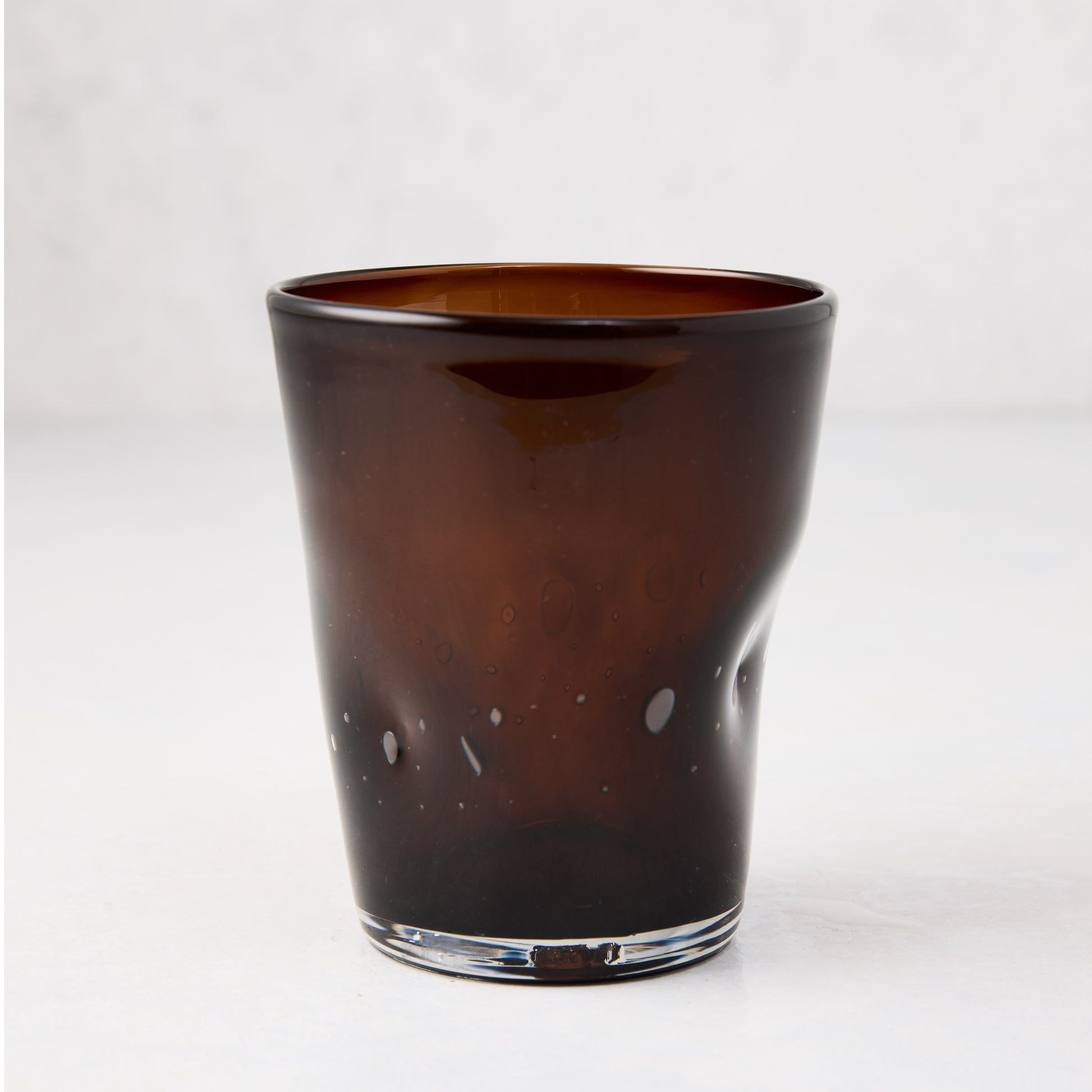 Chocolate brown Henri mouth-blown glass, 8 oz., with unique imperfections and air bubbles.