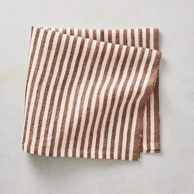 21-inch square linen napkin with chocolate brown ticking stripes on a white base and a brown border.