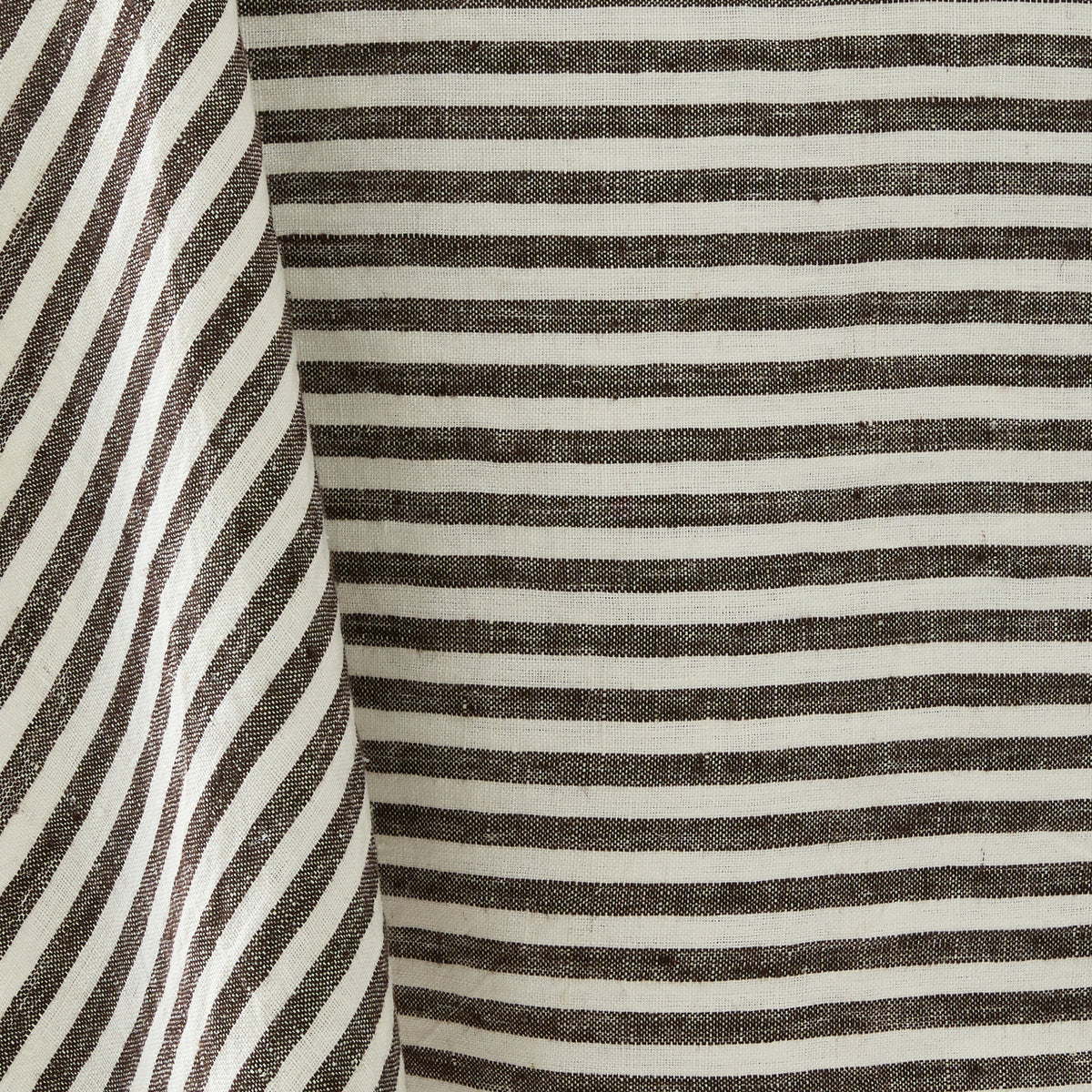 Chocolate brown and white ticking stripe linen tablecloth with a classic striped pattern and textured fabric weave.