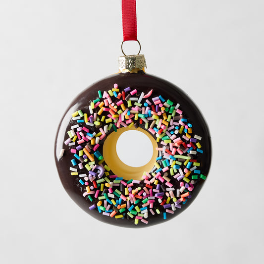 Chocolate donut glass ornament with colorful sprinkles and red ribbon.