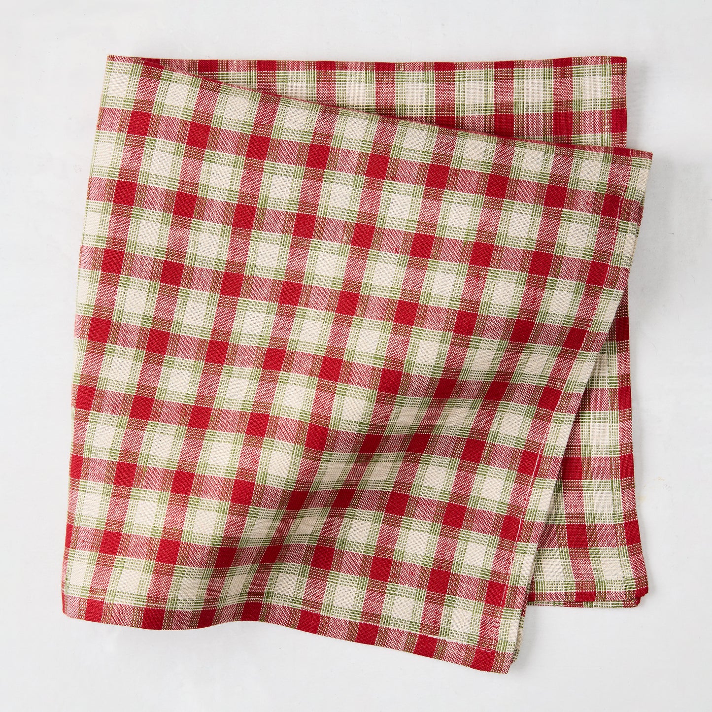 Folded Christmas Cabin Plaid red, beige, and green linen napkin, 21" square.