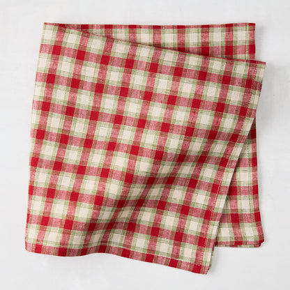 Folded Christmas Cabin Plaid red, beige, and green linen napkin, 21" square.