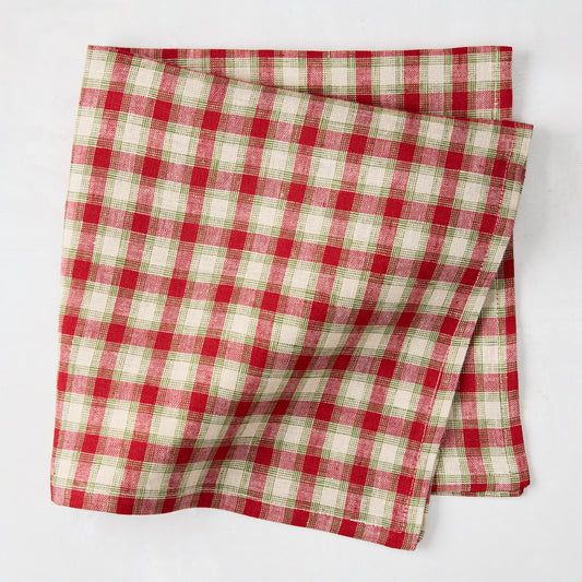 Folded Christmas Cabin Plaid red, beige, and green linen napkin, 21" square.