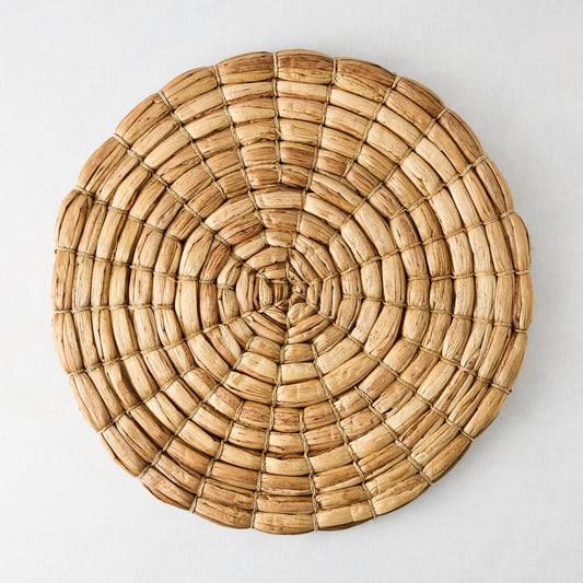 Chunky natural seagrass round woven placemat, 16", with a thick, robust weave.
