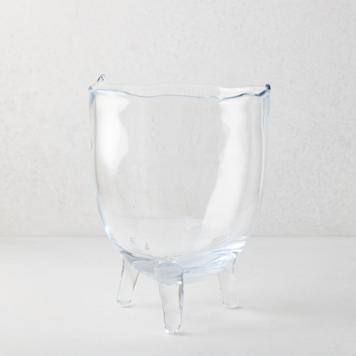 Small Cis Scissor-Cut Glass Bowl, clear mouth-blown glass with wavy rim and three legs.