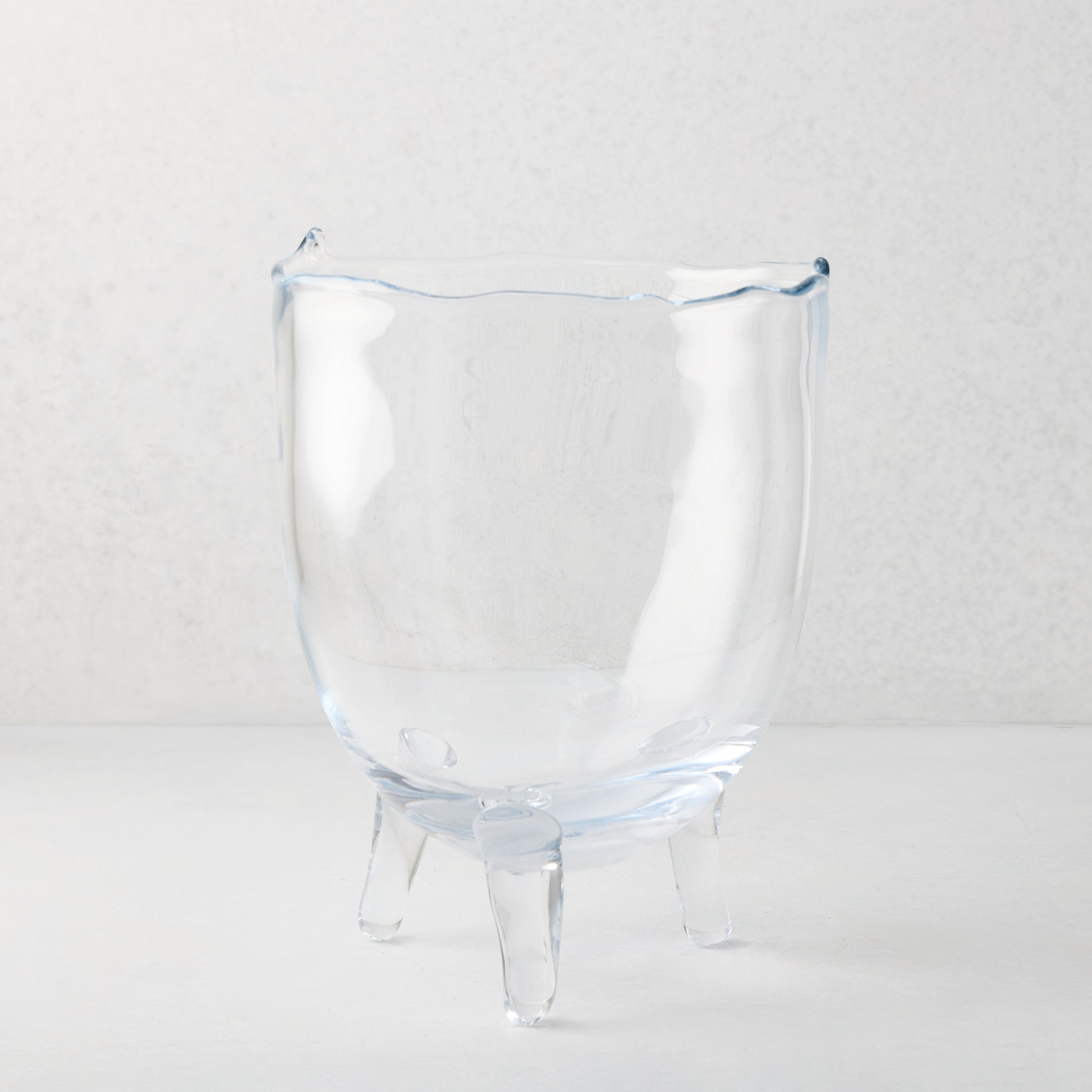 Small Cis Scissor-Cut Glass Bowl, clear mouth-blown glass with wavy rim and three legs.