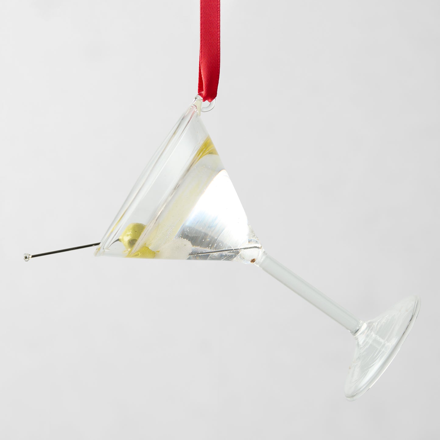 2.5-inch glass martini ornament with a green olive on a pick, hanging from a red ribbon.