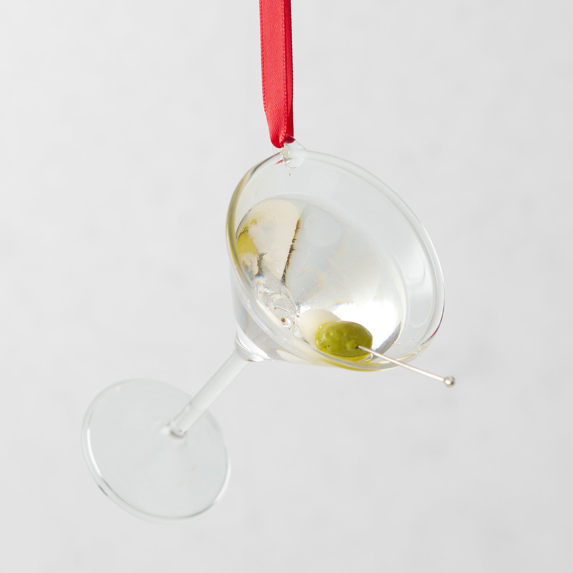 2.5-inch glass martini ornament with a green olive garnish, hanging from a red ribbon.