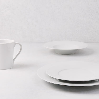 HG Classic white porcelain salad plate, dinner plate, bowl, and mug on a white surface.