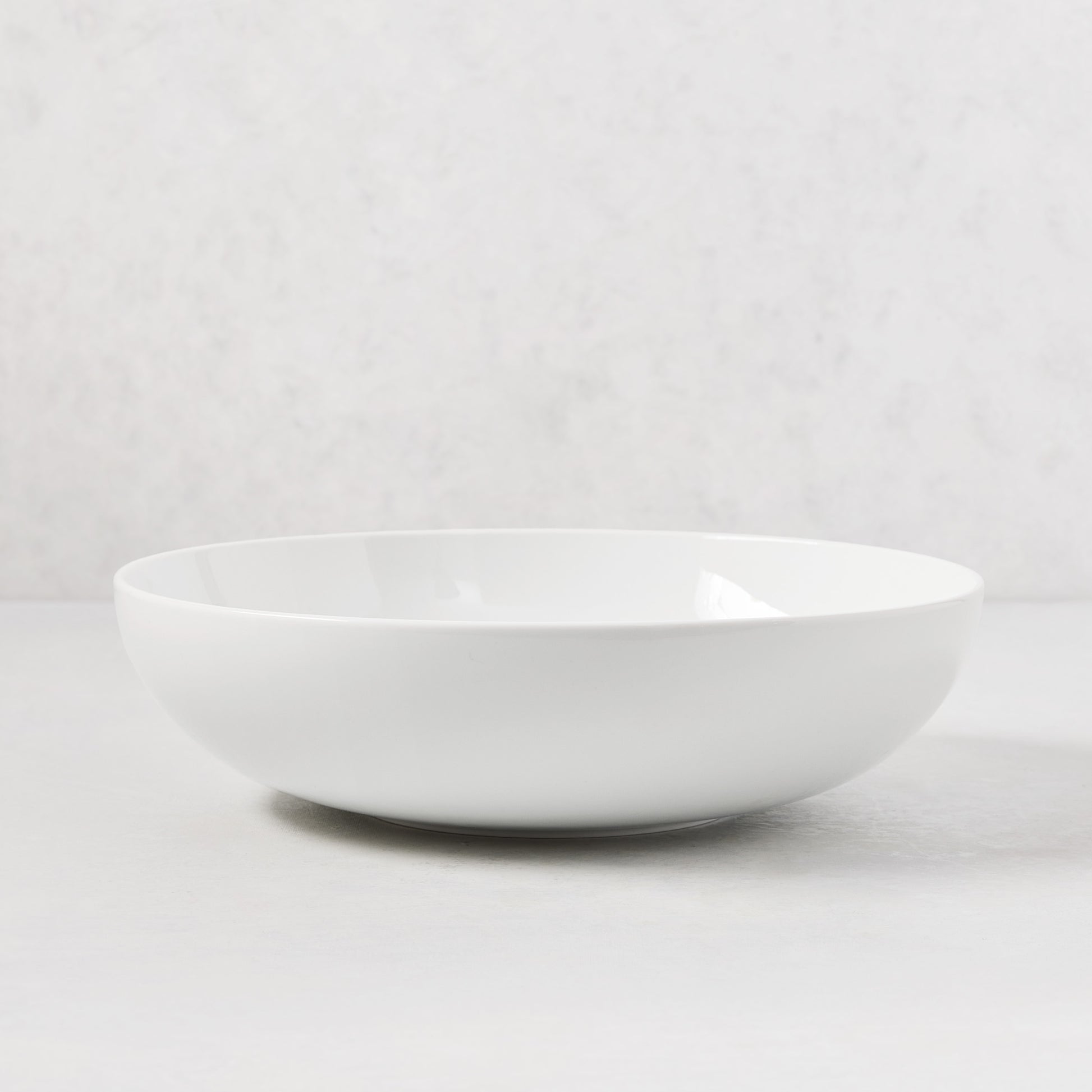 HG Classic 10.5" white porcelain serve bowl with a sleek, simple shape.