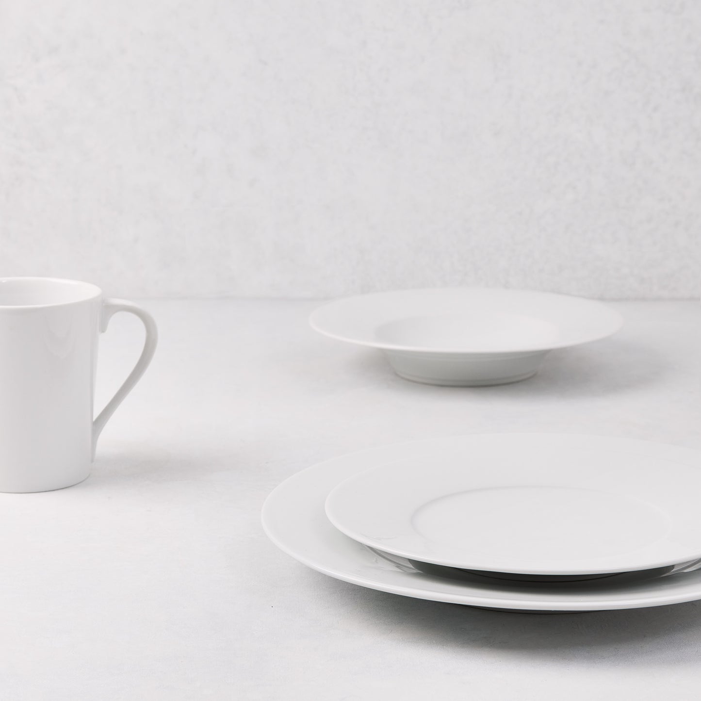 White HG Classic Porcelain 9" soup bowl/plate with wide rim, stacked plates, and mug.