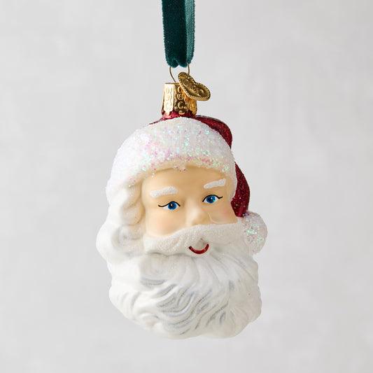 Glass Santa head Christmas tree ornament with glittery white beard, red hat, and blue eyes.