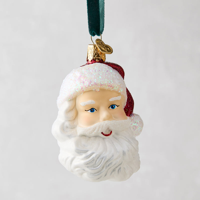 Glass Santa head Christmas tree ornament with glittery white beard, red hat, and blue eyes.