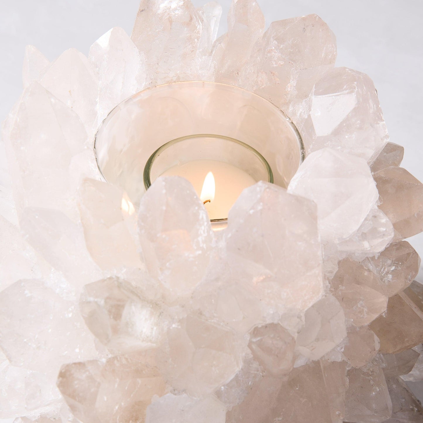 Clear Grande Quartz Votive Candle Holder, 9"Dia x 7"H, with lit candle in glass insert.