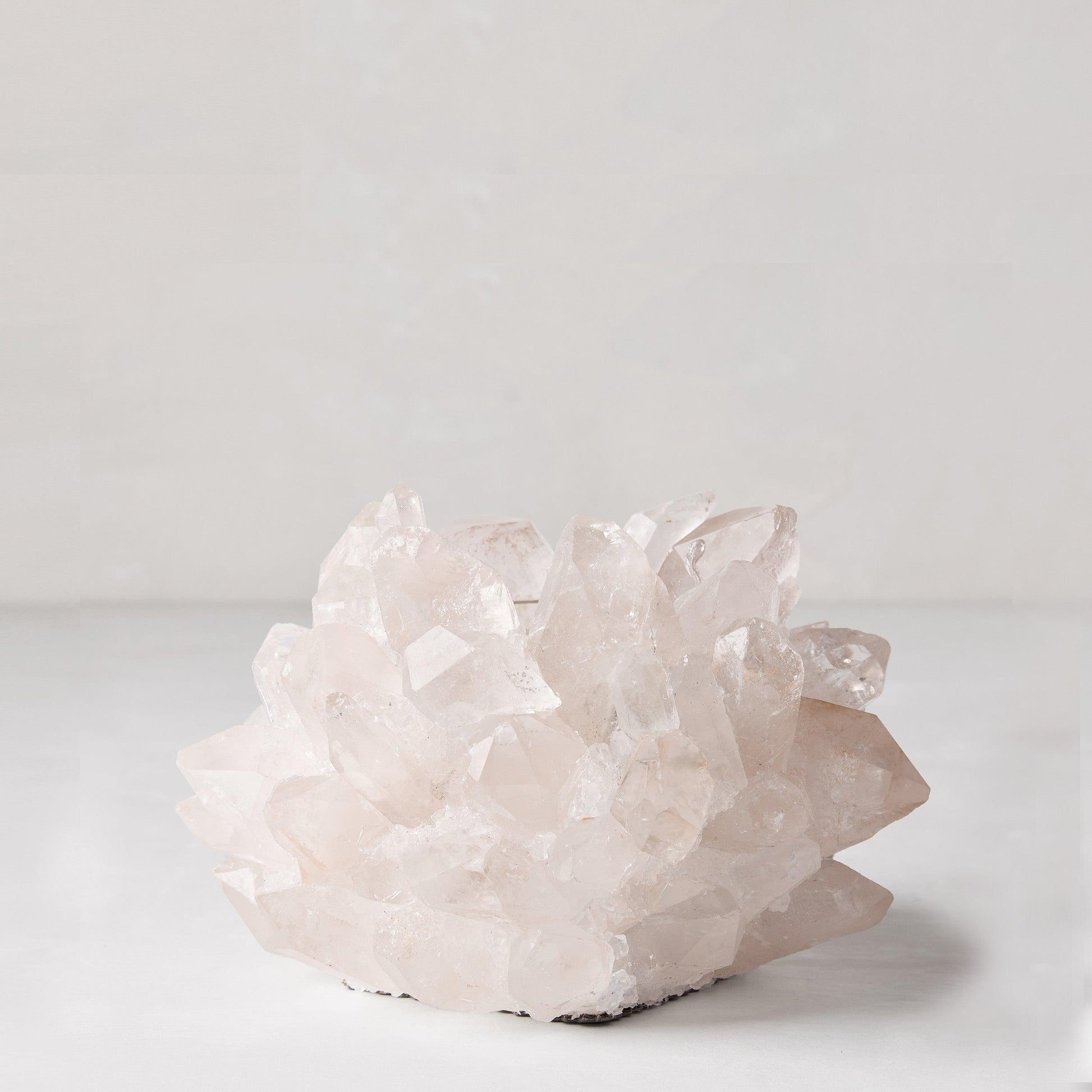 Clear petite quartz votive candle holder, 5"Dia x3"H, made from genuine raw quartz crystals.