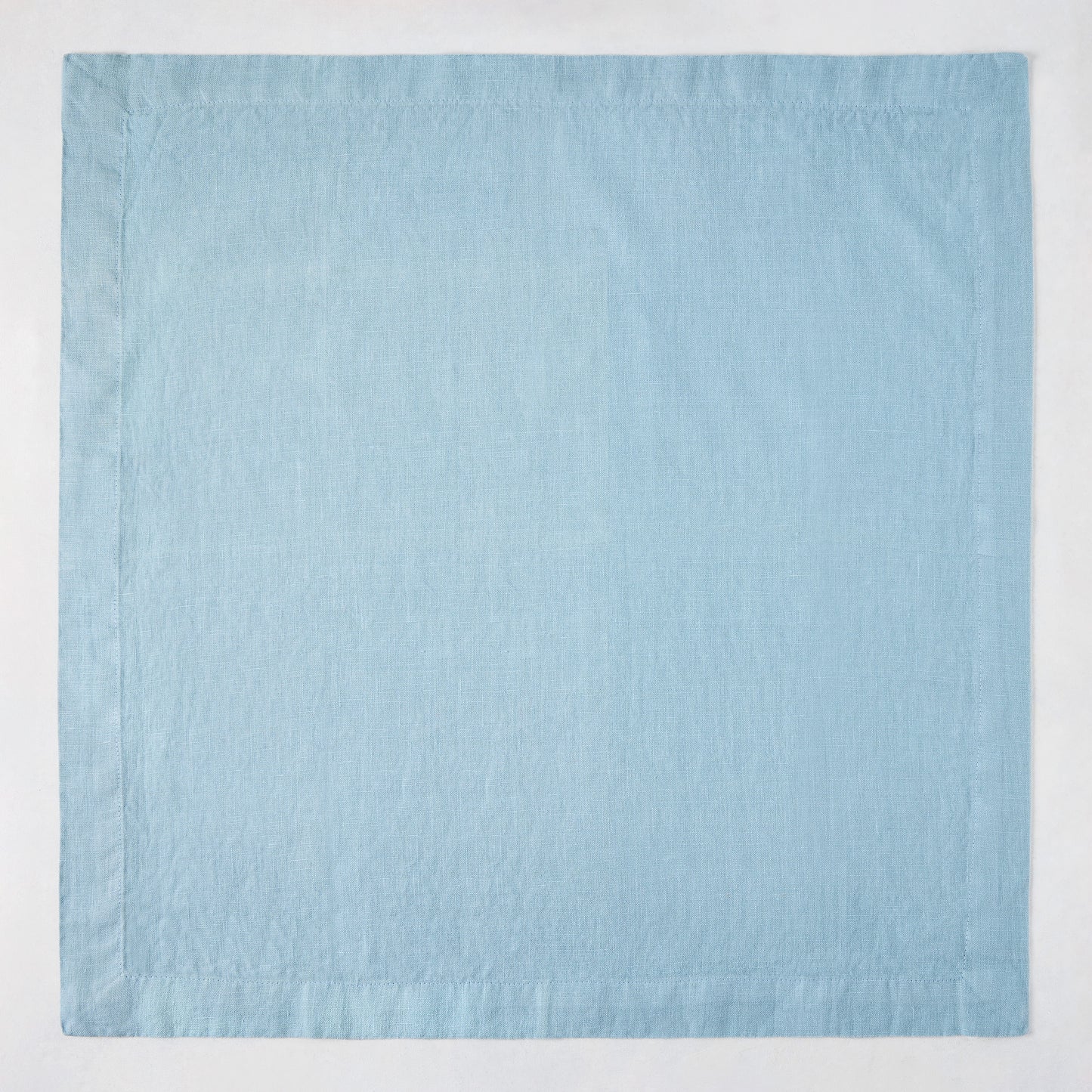 Cloudy HG Signature hand-dyed 22-inch square linen napkin with mitered corners.
