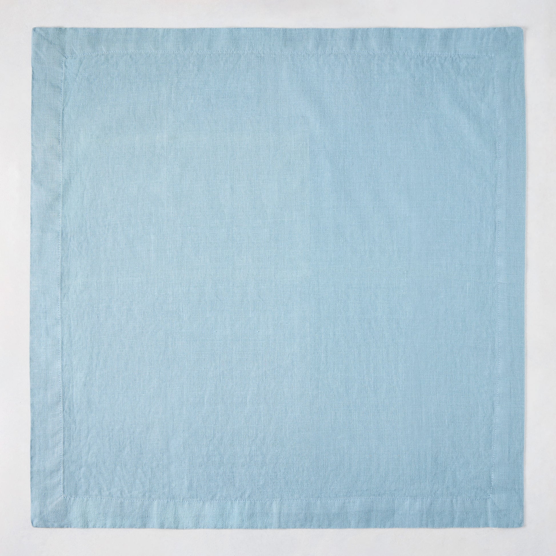 Cloudy HG Signature hand-dyed 22-inch square linen napkin with mitered corners.