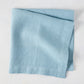 Cloudy HG Signature Hand-dyed Linen Napkin, folded, 22-inch square, muted blue-gray.
