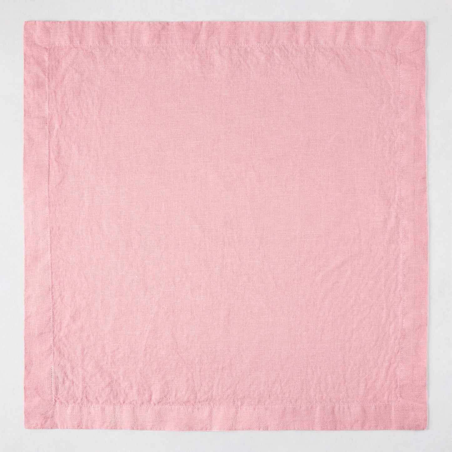 Clover Pink HG Signature hand-dyed 22-inch linen napkin with mitered corners, flat on a white surface.