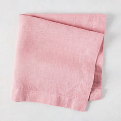 Clover Pink HG Signature hand-dyed linen napkin, 22-inch square, folded on a light surface.