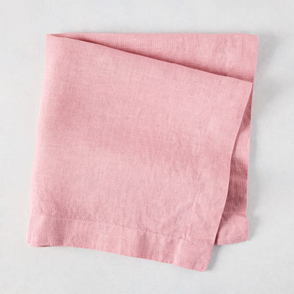 Clover Pink HG Signature hand-dyed linen napkin, 22-inch square, folded on a light surface.