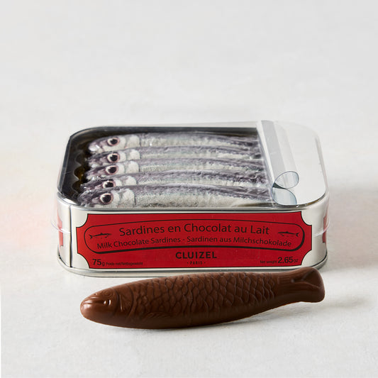 Cluizel Milk Chocolate Tinned Sardines, a silver tin with red label, open to show 5 chocolate sardines, plus one loose.