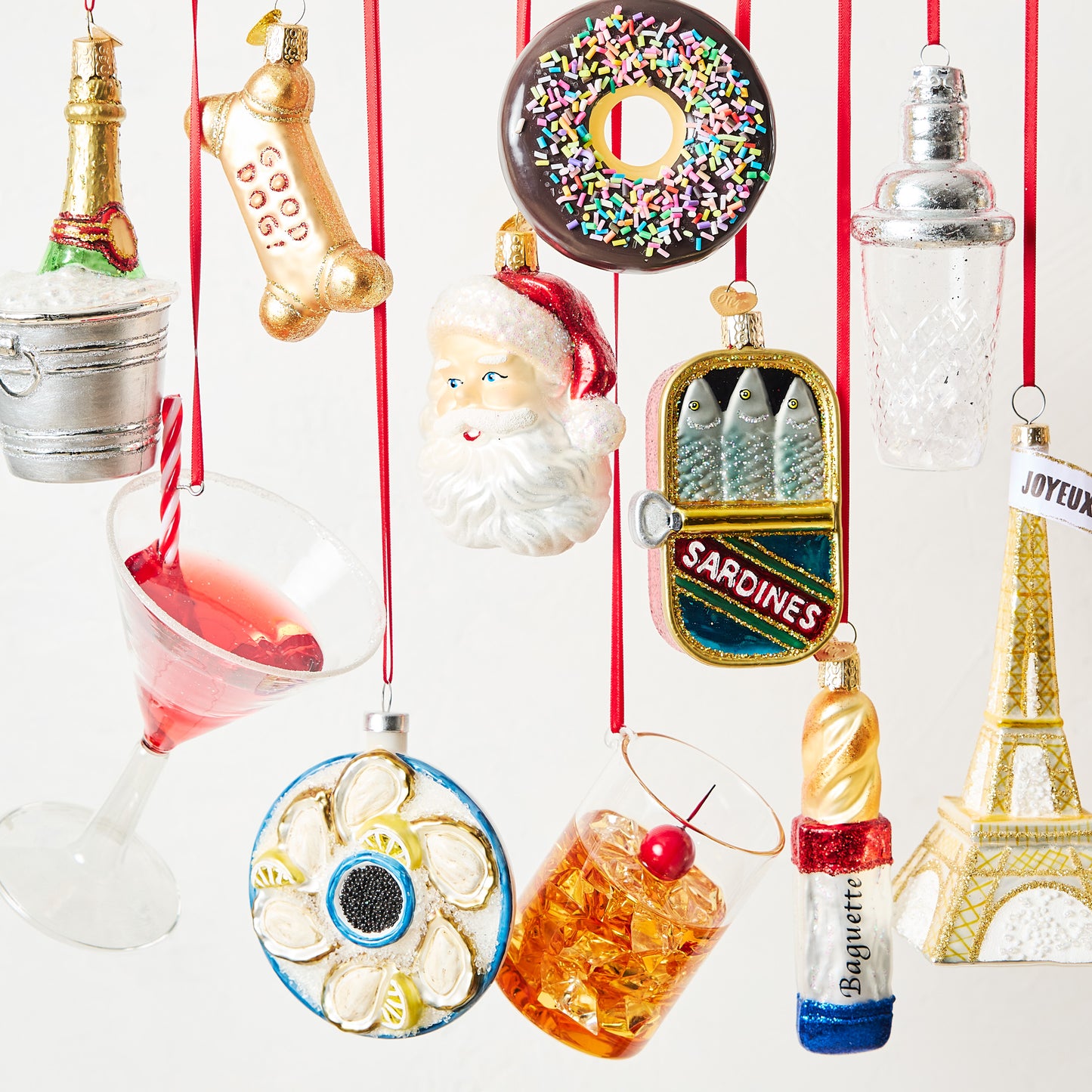 Clear glass cocktail shaker Christmas ornament with silver lid detail, 4.5 inches tall, hanging on a red ribbon.