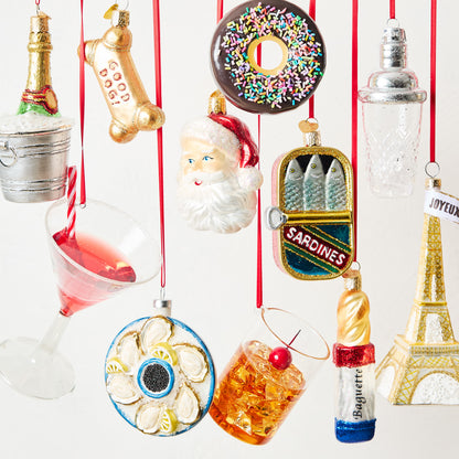Clear glass cocktail shaker Christmas ornament with silver lid detail, 4.5 inches tall, hanging on a red ribbon.
