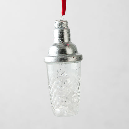 Silver and clear glass cocktail shaker Christmas ornament with a textured diamond pattern and red hanging ribbon.