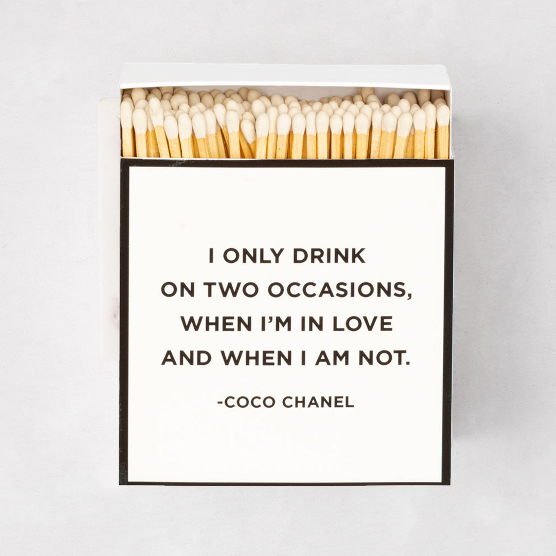 Oversized "Coco Chanel" boxed matches with a white box, black border, and quote.