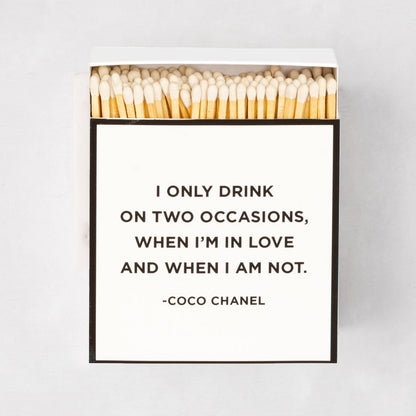 Oversized "Coco Chanel" boxed matches with a white box, black border, and quote.
