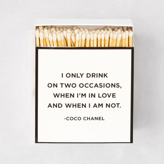Oversized "Coco Chanel" boxed matches with a white box, black border, and quote.