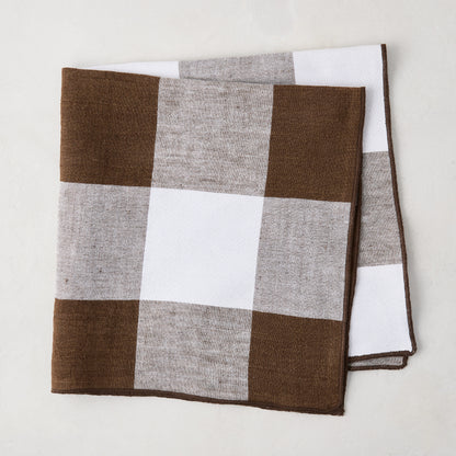 Cocoa brown buffalo check linen napkin, 20x20 inches, folded on a white surface.