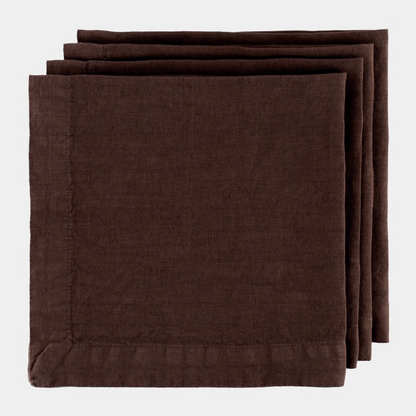 Stack of three folded Cocoa HG brown hand-dyed 22" linen napkins with mitered corners.