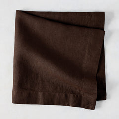 Cocoa HG hand-dyed 22" square brown linen napkin, folded on a light surface.