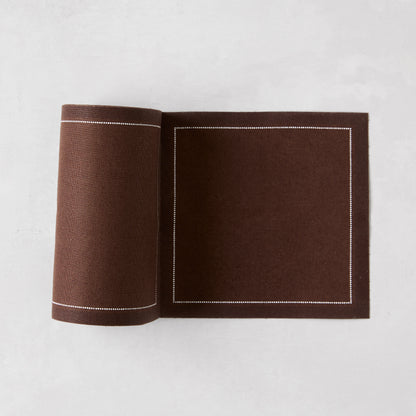 Cocoa brown cotton tear-off cocktail napkin roll with white dotted border.