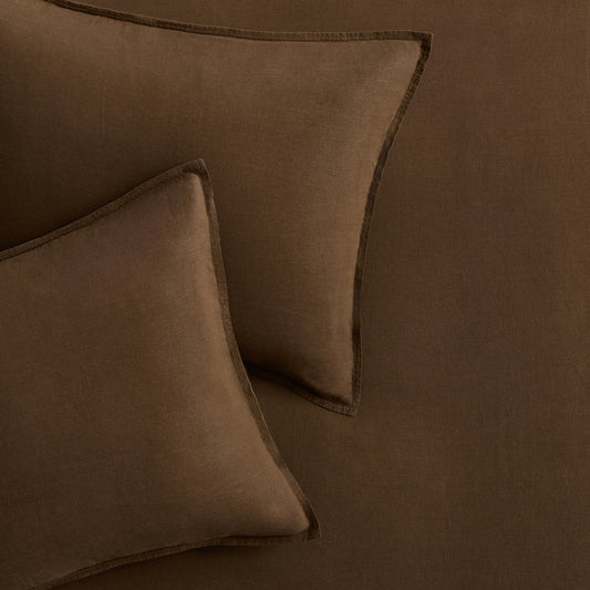 Set of two coffee brown European washed linen euro shams with a simple flange border.