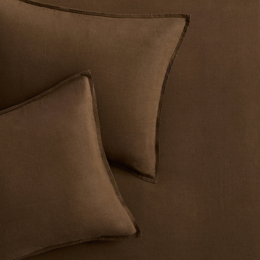 Set of two coffee brown European washed linen euro shams with a simple flange border.