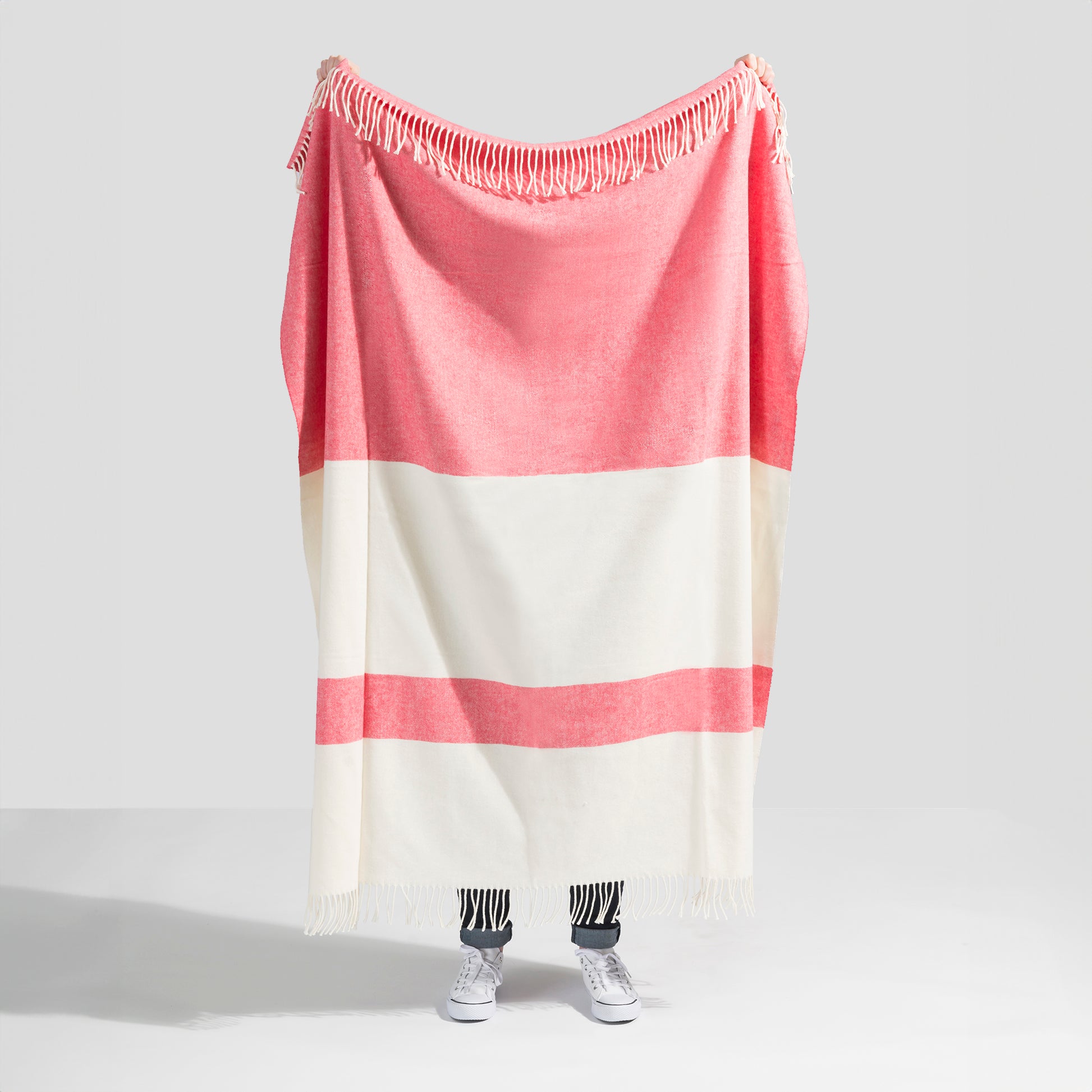Sydney Herringbone Stripe Throw in coral and cream, cotton-acrylic blend with fringe.