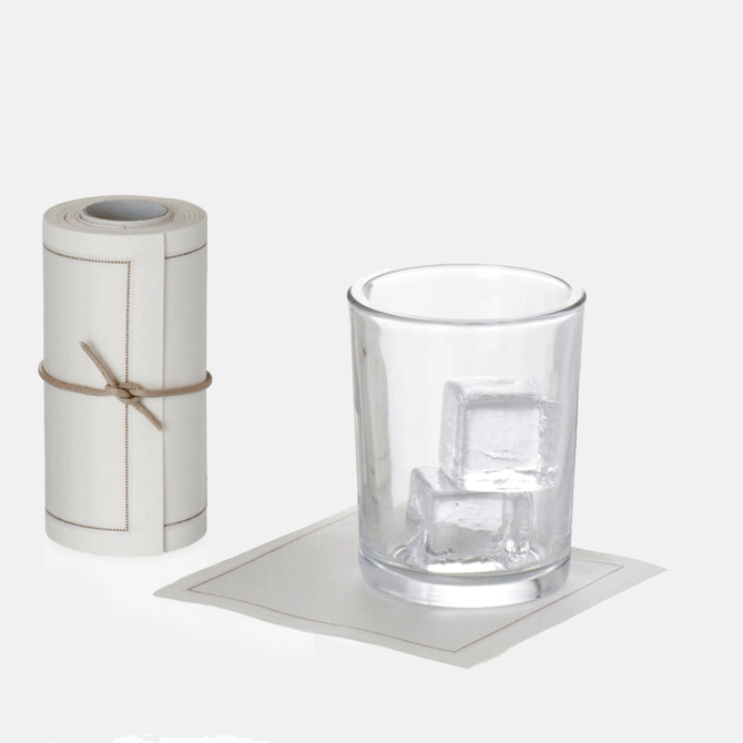 Roll of 50 cream cotton tear-off cocktail napkins with a glass of ice on one napkin.