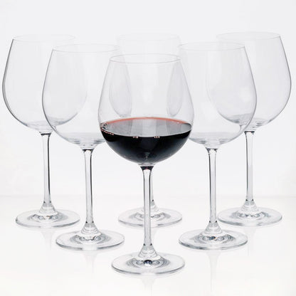 Set of 6 clear crystal Burgundy stem wine glasses, one filled with red wine.