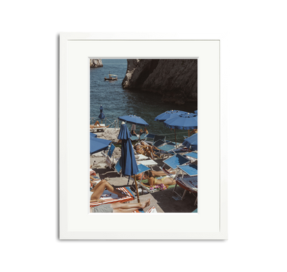 Da Luigi II Framed Wall Art Print: Vintage photo of Amalfi Coast beach club with blue umbrellas and sunbathers.