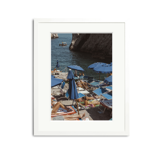 Da Luigi II Framed Wall Art Print: Vintage photo of Amalfi Coast beach club with blue umbrellas and sunbathers.