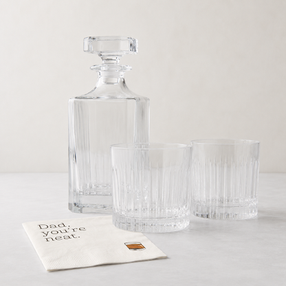 Clear eco-crystal Regent decanter and two double old fashioned glasses with "Dad, you're neat" cocktail napkins.