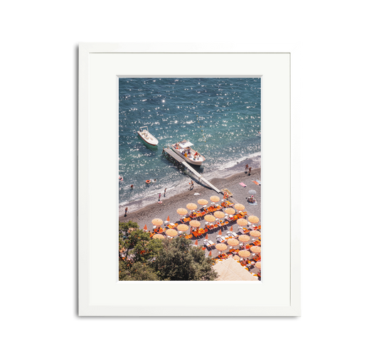 D'Arienzo II framed wall art print of a vibrant Italian beach with orange striped umbrellas and boats.