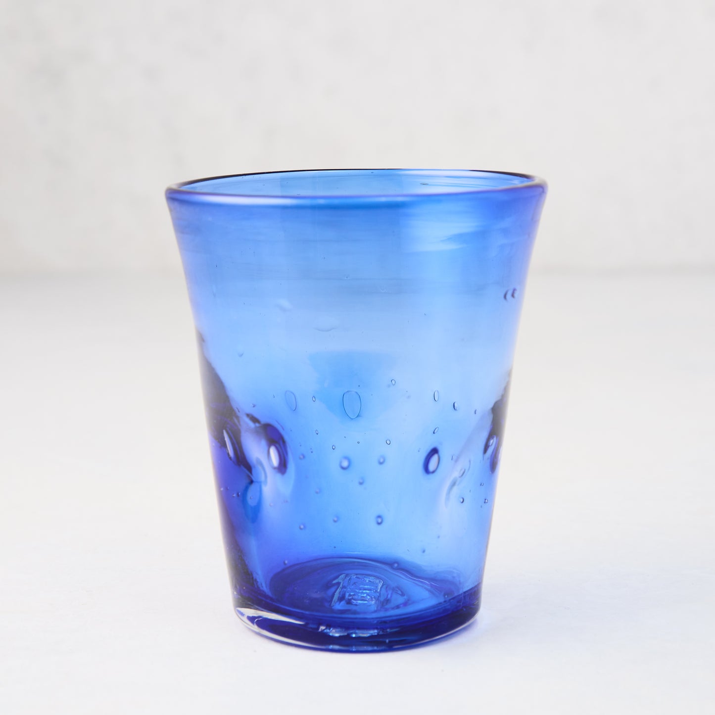 Dark blue Henri 8 oz. mouth-blown glass with unique imperfections and small air bubbles.