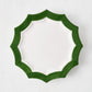 Stella ceramic salad plate with a white center and a dark green scalloped rim on a white background.