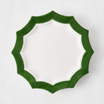 Stella ceramic salad plate with a white center and a dark green scalloped rim on a white background.
